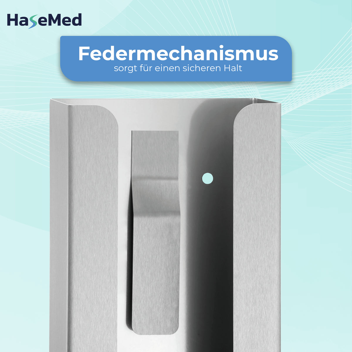 Dettaglio della molla del supporto HaseMed HAS-30 in acciaio inox per una scatola di guanti; testo in tedesco.