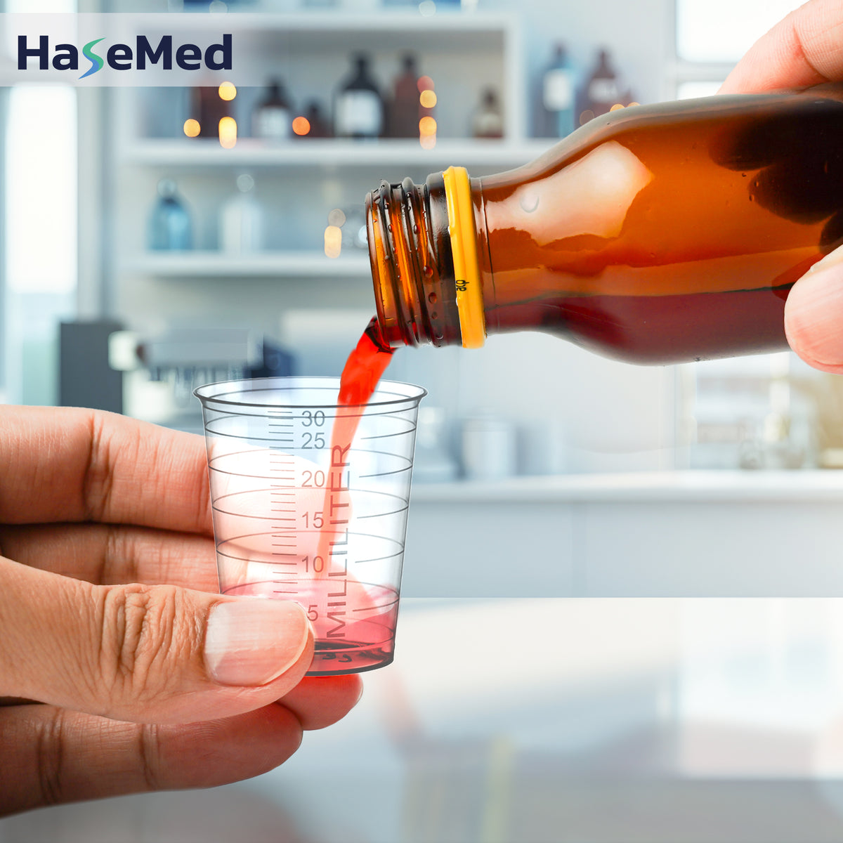 Bicchierino per medicinali HaseMed da 30 ml trasparente in uso; venduto in confezioni da 80 bicchierini di un solo colore, senza coperchi. Liquido e flacone non inclusi.